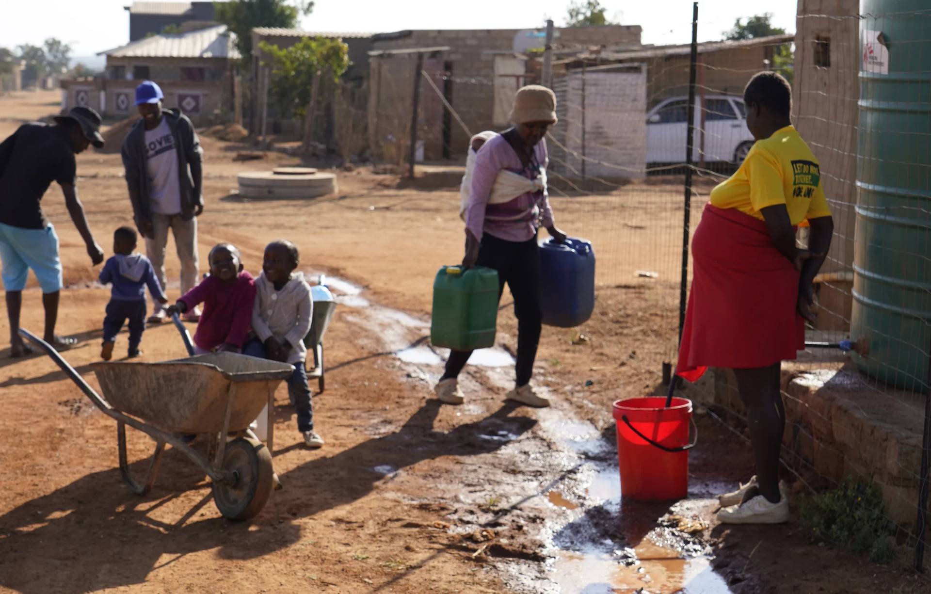 Residents gather at a water tank in the Hammanskraal township in Pretoria, South Africa, on May 22, 2024. (Credit: Denis Farrell/AP.)